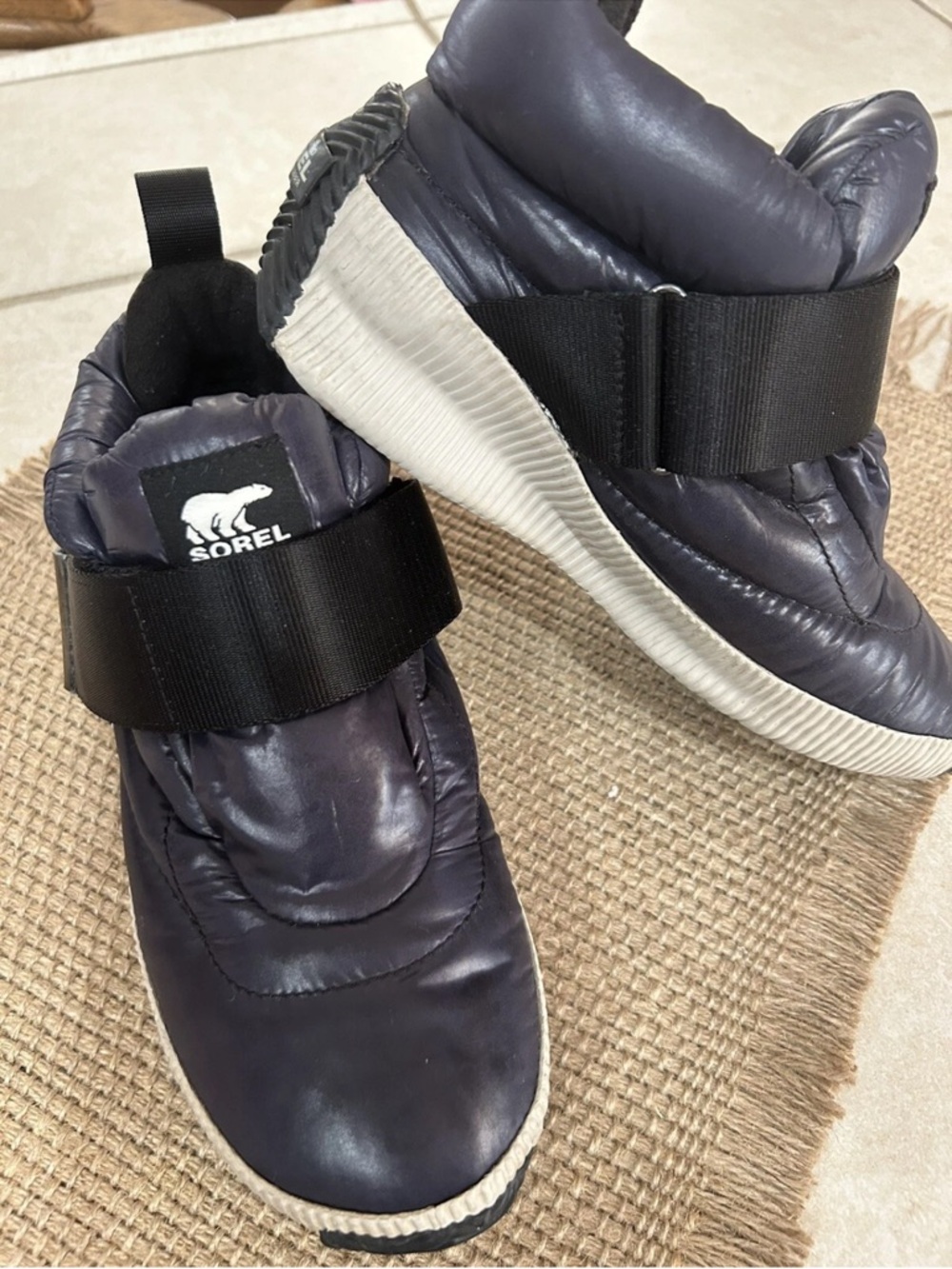 Sorel Navy Quilted Slip-On Boots with Black Strap and White Sole